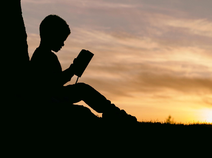 Silhouette of Child Sitting Behind a Tree at Sunset,  Photo by Aaron Burden on Unsplash