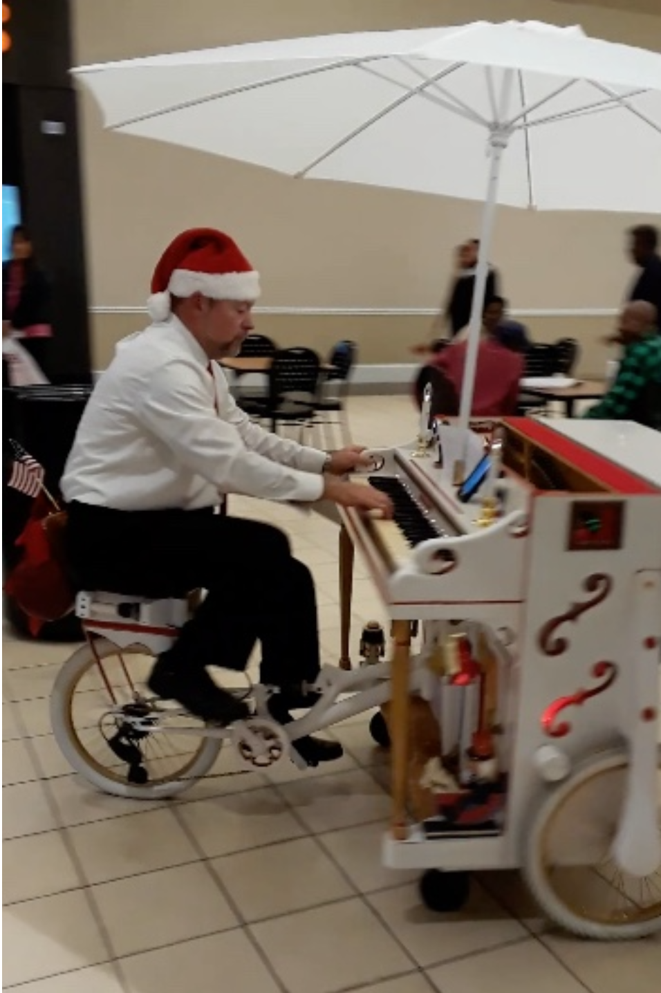 "Pedaling and Playing the Triano at the Statesboro Mall in 2019" by Brianna Van Deursen